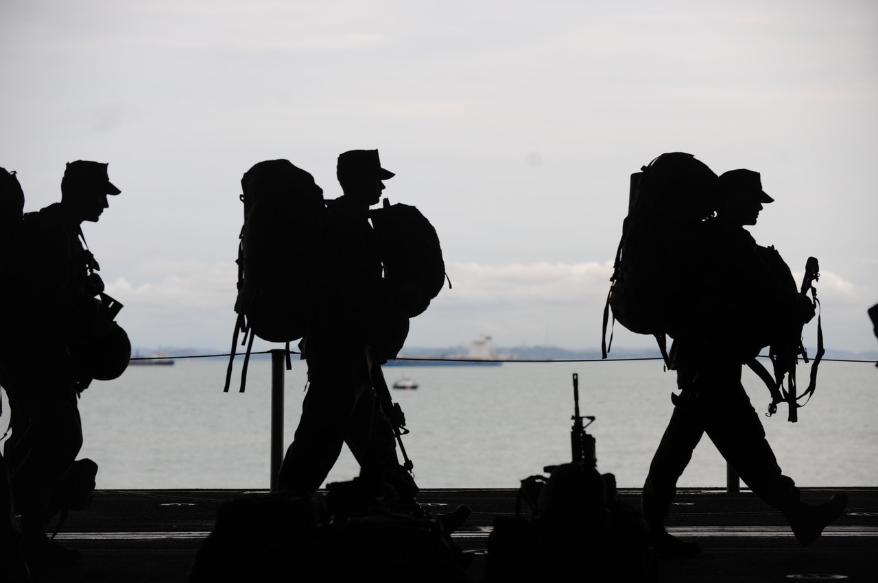 army wearing backpacks silhouette