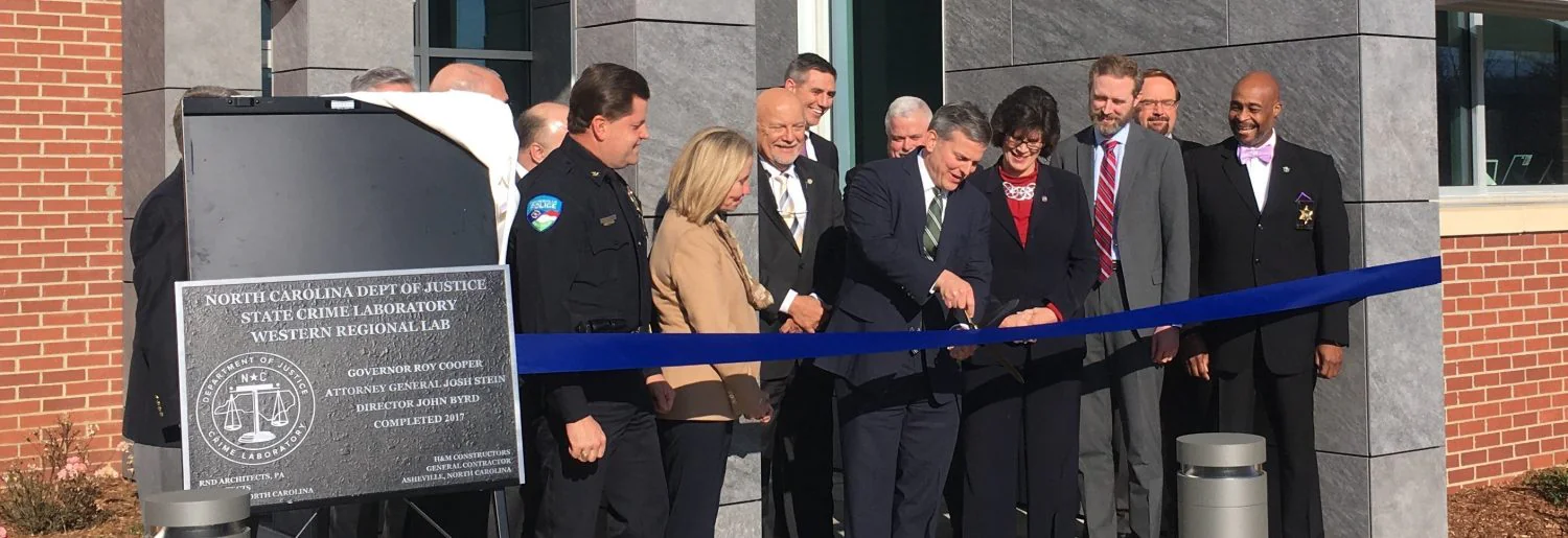 cutting the ribbon to open state crime lab